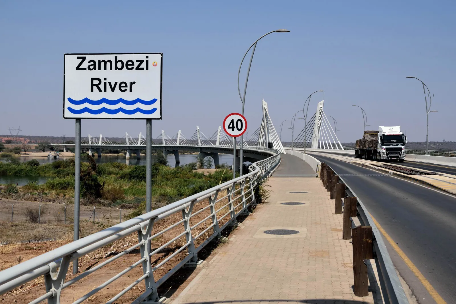 A freight truck crossing Kazungula Bridge beside its central railway track